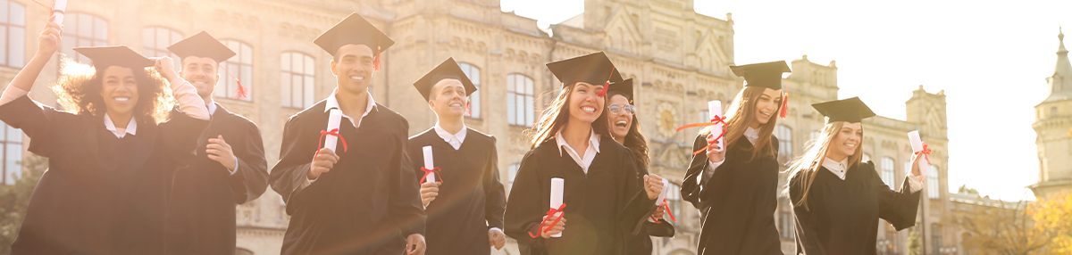 Happy students with diplomas near campus.
