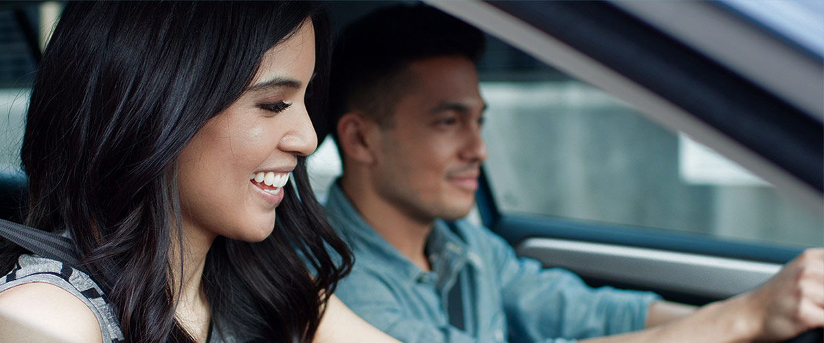 Happy couple driving
